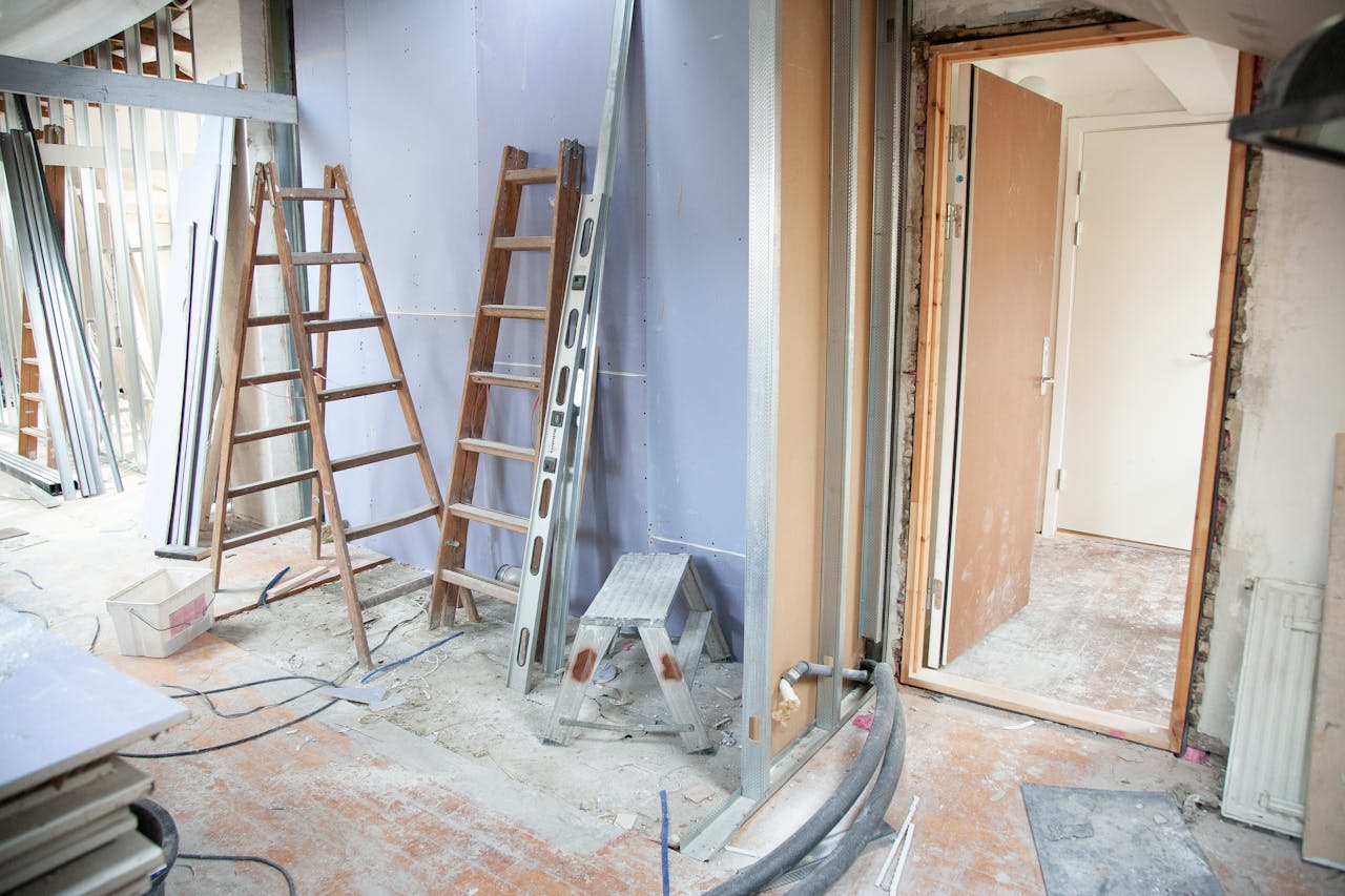 Mastering the First Impression: Your intriguing post title goes here Construction site featuring ladders and tools in a home renovation setting.